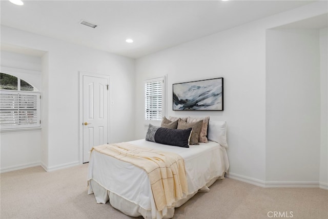 bedroom featuring light colored carpet