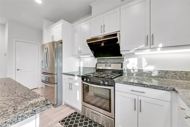 kitchen featuring white cabinets, under cabinet range hood, stone counters, and stainless steel appliances