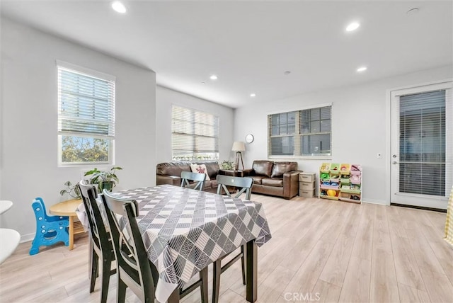 dining space featuring light wood-style floors, a wealth of natural light, and recessed lighting