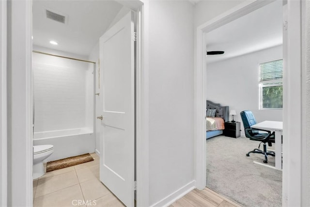 full bathroom featuring visible vents, toilet, tub / shower combination, connected bathroom, and tile patterned floors