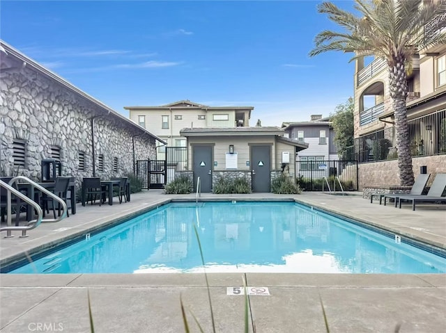 pool featuring a patio and fence