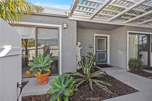 doorway to property featuring a pergola