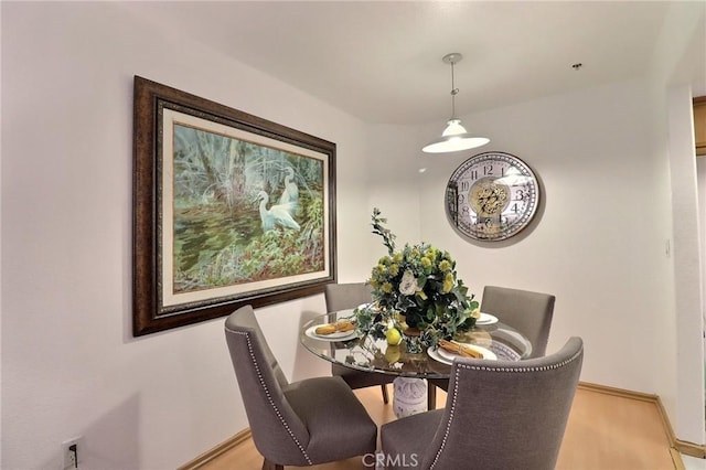 dining area featuring light wood-type flooring