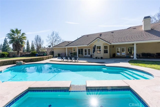 view of pool featuring french doors, ceiling fan, and a patio area