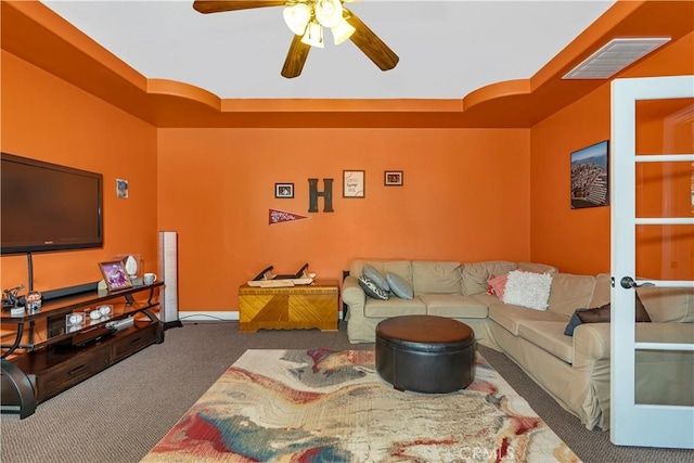 living room with dark colored carpet and ceiling fan