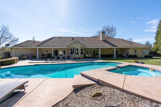 view of pool featuring an in ground hot tub and a patio