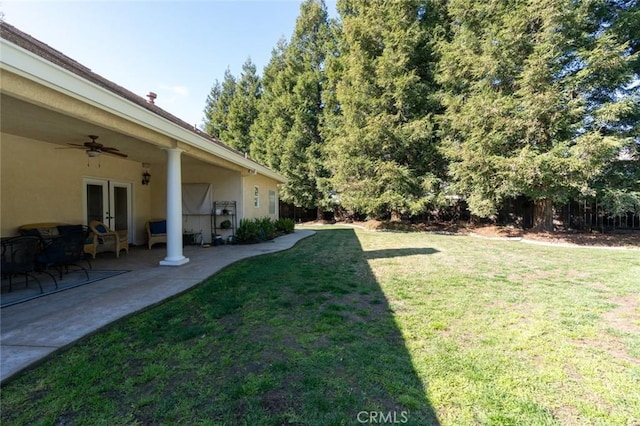 view of yard featuring a patio and ceiling fan