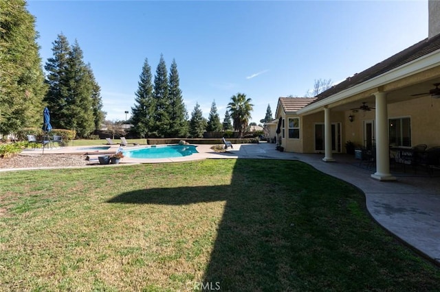 view of yard featuring ceiling fan and a patio