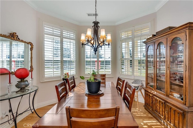 dining area with ornamental molding and plenty of natural light