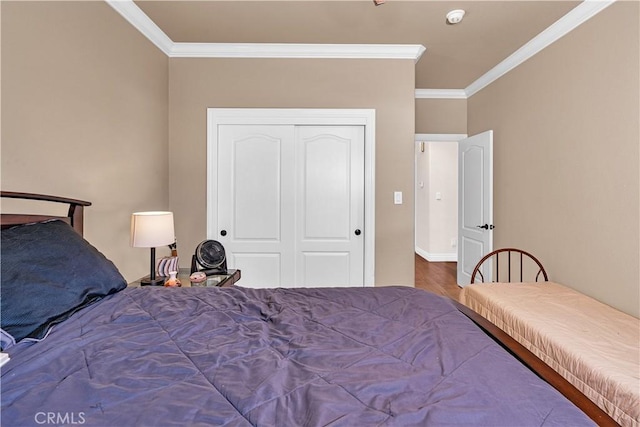 bedroom with ornamental molding and a closet