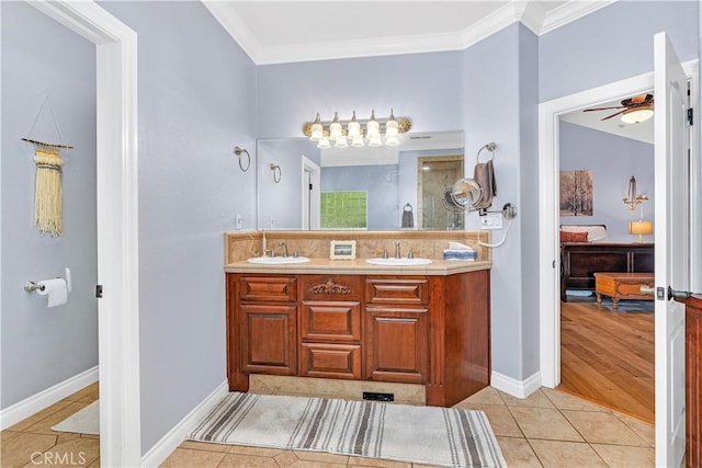 bathroom with tile patterned flooring, crown molding, vanity, and ceiling fan