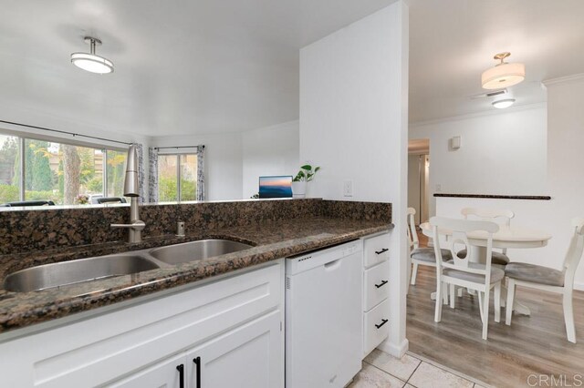 5708 Baltimore Dr Unit 376, La Mesa, CA 91942 - kitchen with white cabinetry, ornamental molding, dark stone countertops, a sink, and dishwasher