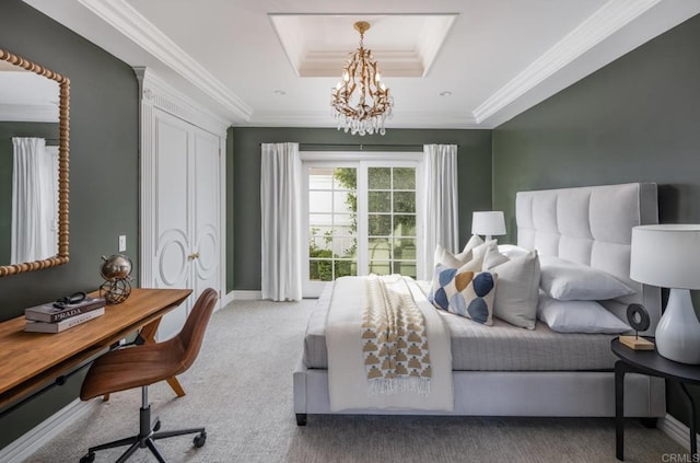 bedroom featuring crown molding, a tray ceiling, a chandelier, and carpet