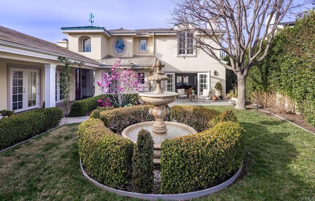 back of house with a patio, a yard, and french doors