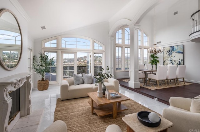 sunroom / solarium with vaulted ceiling, decorative columns, and a chandelier