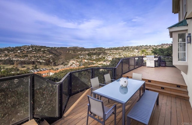 wooden terrace featuring a grill and a mountain view