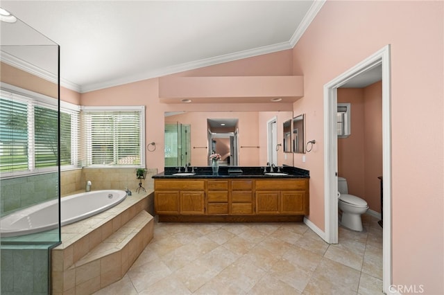 bathroom with lofted ceiling, vanity, toilet, tiled tub, and crown molding