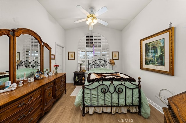 bedroom featuring vaulted ceiling, ceiling fan, and light wood-type flooring