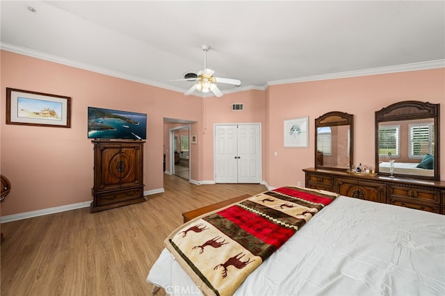 bedroom featuring ornamental molding, ceiling fan, and light wood-type flooring