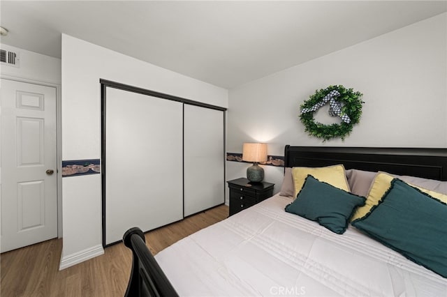 bedroom featuring hardwood / wood-style flooring and a closet