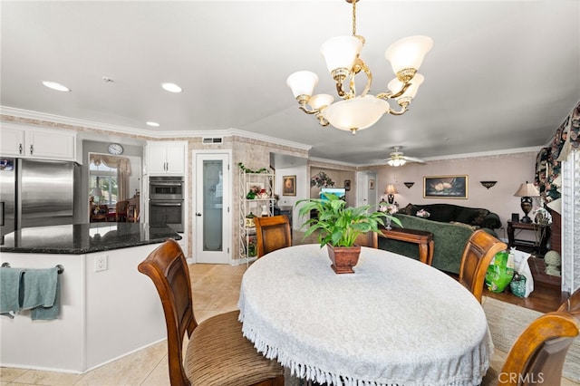 tiled dining room with crown molding and ceiling fan with notable chandelier