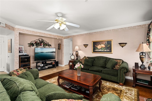 living room featuring crown molding, wood-type flooring, and ceiling fan