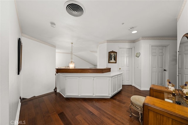 interior space with white cabinets, dark hardwood / wood-style flooring, and decorative light fixtures