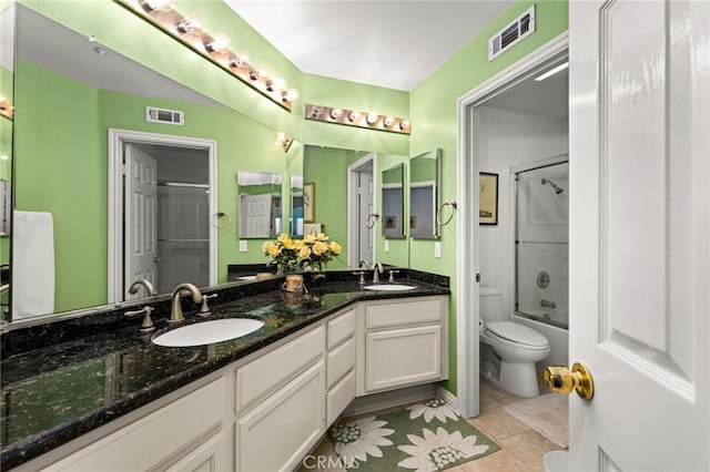 full bathroom with toilet, tile patterned floors, shower / bath combination with glass door, and vanity