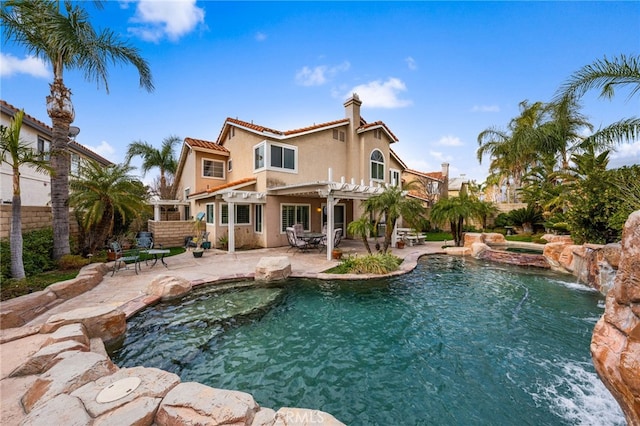 view of swimming pool with an in ground hot tub, a patio area, and a pergola