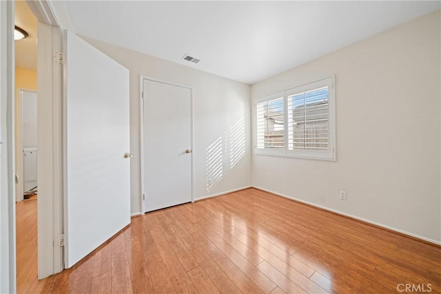 unfurnished bedroom featuring a closet and light hardwood / wood-style flooring