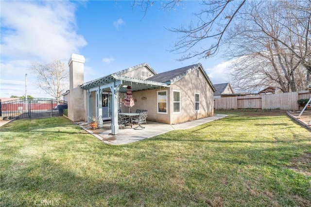 back of property featuring a yard, a pergola, and a patio area