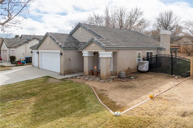 view of front of house with a garage and a front lawn