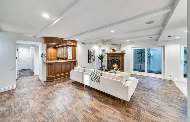 23216 Park Esperanza, Calabasas, CA 91302 - living room featuring beamed ceiling, dark wood-style floors, baseboards, a lit fireplace, and ceiling fan