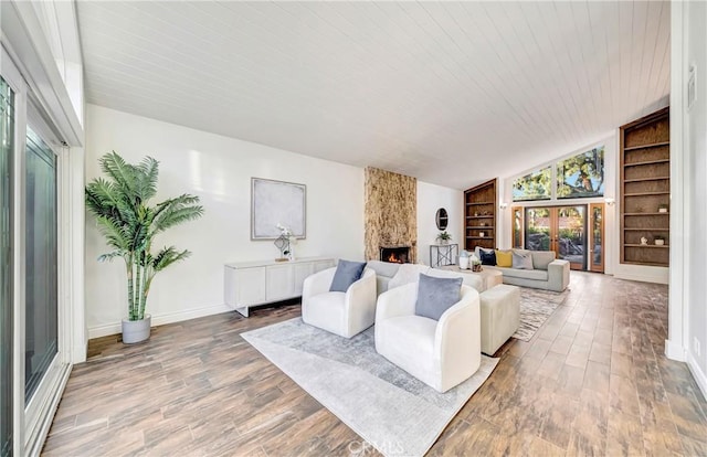 23216 Park Esperanza, Calabasas, CA 91302 - living area with built in shelves, a large fireplace, baseboards, wood finished floors, and wood ceiling