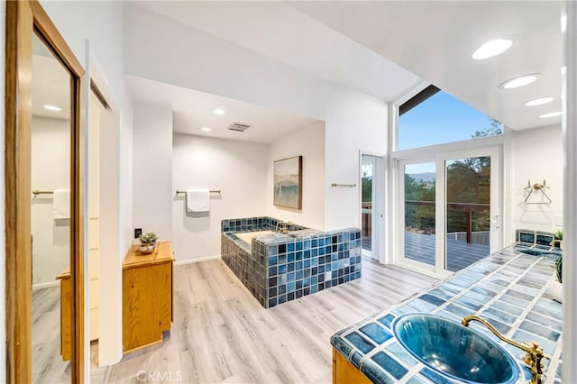 23216 Park Esperanza, Calabasas, CA 91302 - full bathroom featuring wood finished floors, a garden tub, and baseboards