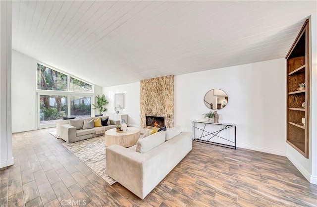 23216 Park Esperanza, Calabasas, CA 91302 - living room featuring wood finished floors, a large fireplace, lofted ceiling, wood ceiling, and baseboards