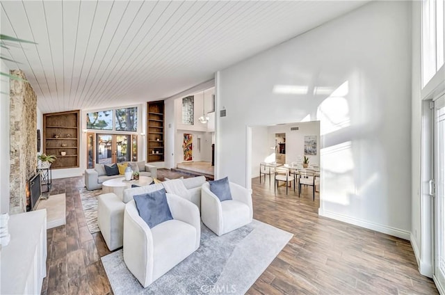 23216 Park Esperanza, Calabasas, CA 91302 - living room featuring built in features, wooden ceiling, a fireplace with raised hearth, baseboards, and wood finished floors