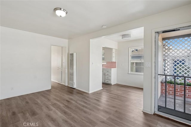interior space featuring wood finished floors and baseboards