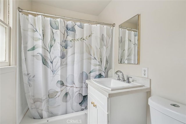 bathroom featuring toilet, vanity, and shower / tub combo with curtain