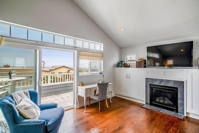 office space featuring dark wood-type flooring, a fireplace, and high vaulted ceiling