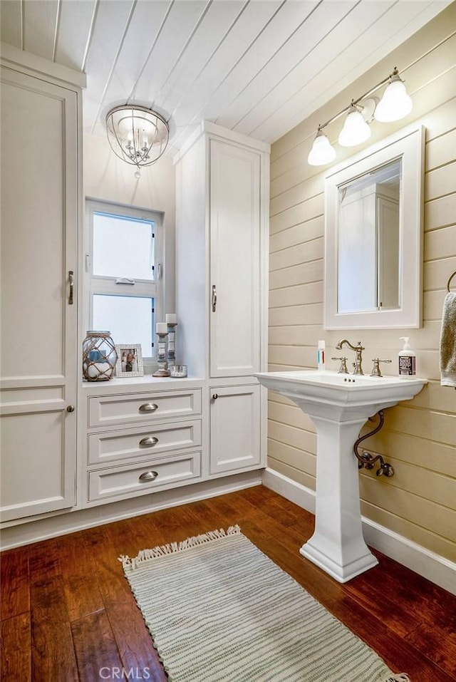 bathroom featuring an inviting chandelier, wood ceiling, wood-type flooring, and wooden walls