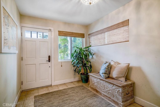 tiled foyer entrance with baseboards