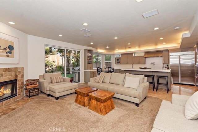 tiled living room with a tray ceiling