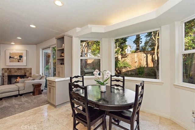 dining room featuring a tiled fireplace