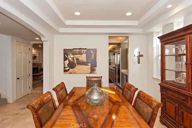 dining space featuring a tray ceiling