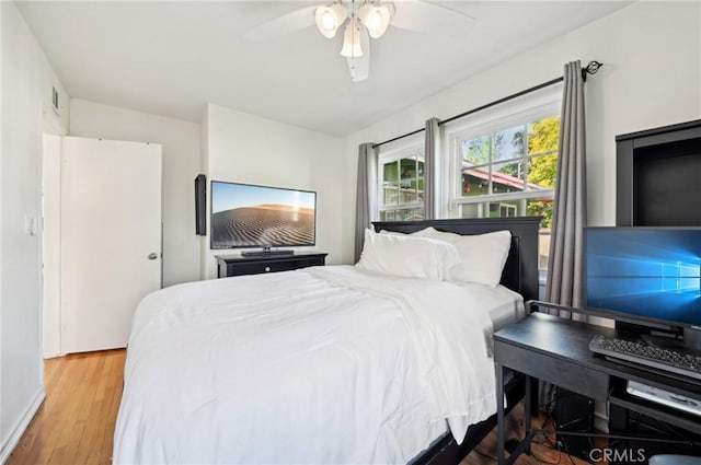 bedroom featuring a ceiling fan and wood finished floors