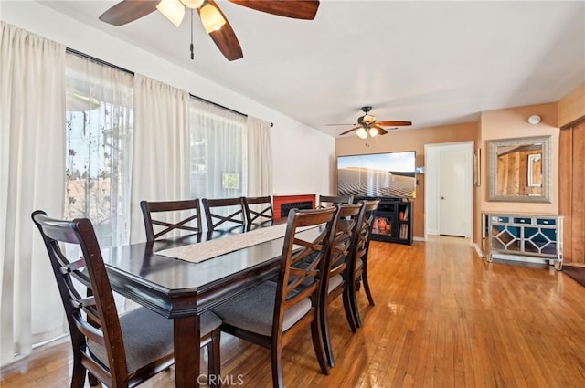 dining space with ceiling fan and wood finished floors