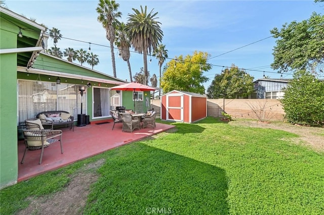 view of yard featuring an outbuilding, a patio, a shed, a fenced backyard, and an outdoor living space