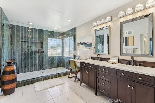 bathroom featuring tiled shower, vanity, and tile patterned floors