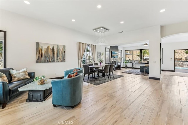 living room featuring ceiling fan and light wood-type flooring